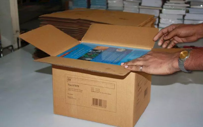 A corrugated box with books that are ready for being handed over to the logistics department and palletisation process