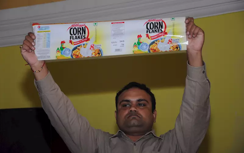 Rahul Kumar of PrintWeek India holds up an innovative sample by Mudrika Labels of Mumbai