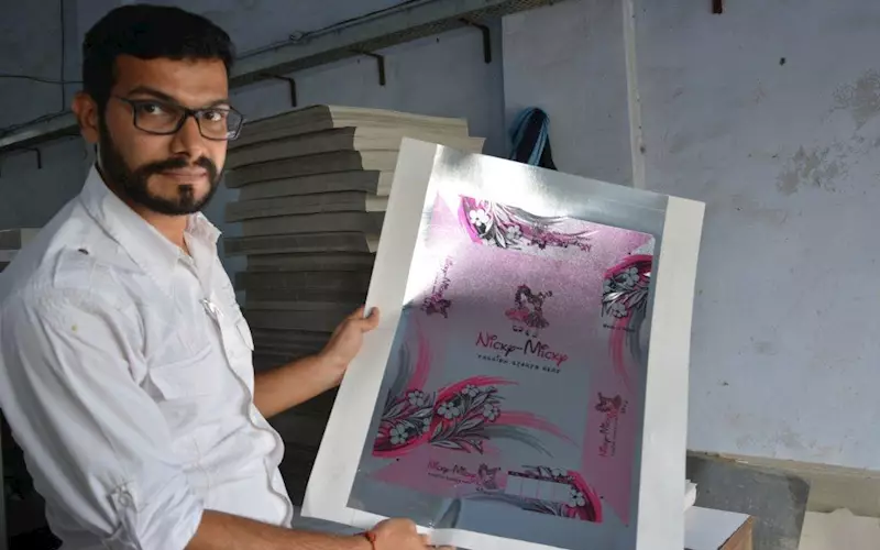 Jain showcasing the micro-embossed MetPET saree box