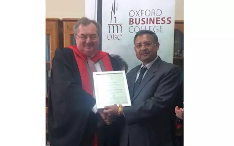 Arun Maheshwari received the award from Steve Bristow of Oxford Business College