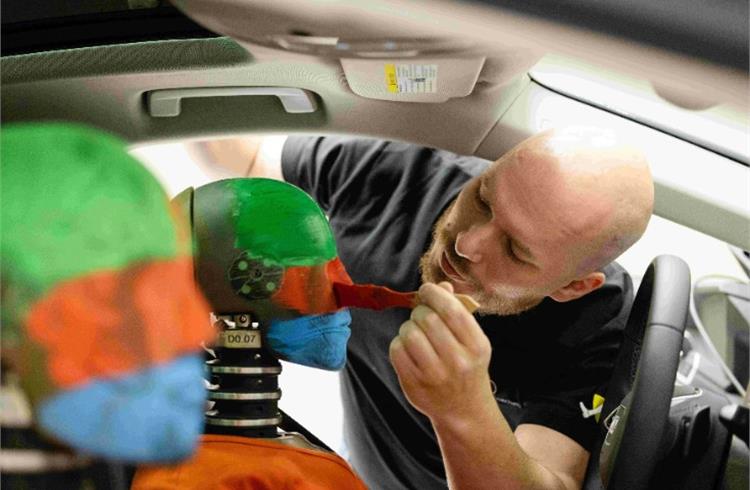 Two crash-test dummies being prepared for a crash test at the new Vehicle Safety Center.