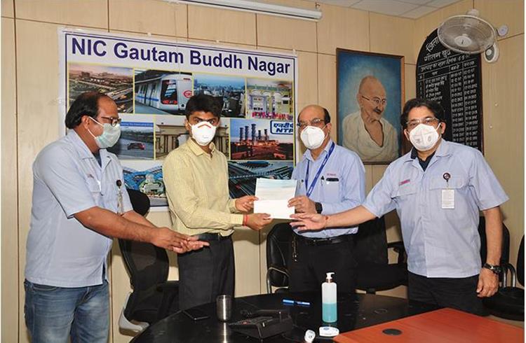 Suhas  Yathiraj, DM, Gautam Buddh Nagar, UP receiving a cheque of Rs 25 lakh from Sanjiv Paul, SVP and Vimal Raina, VP, India Yamaha Motor in June 2020