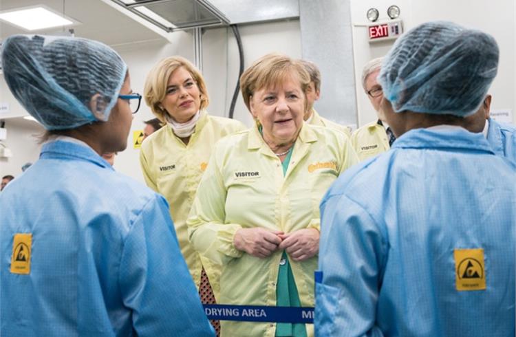 Dr Merkel seen speaking to staffers at the Manesar plant. 