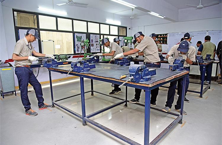 Putting theory into practice. Students convert engineering drawings into physical job works by milling, drilling and filing in the workshop