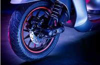 The front suspension is handled by a single-sided trailing arm unit that appears to have coilover setup with an exposed external spring.