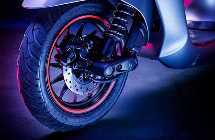 The front suspension is handled by a single-sided trailing arm unit that appears to have coilover setup with an exposed external spring.