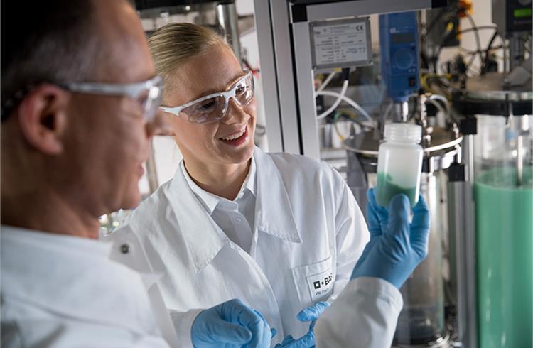 Physical laboratory technician Joerg Mai (left) and chemist Dr Daniela Pfister (right) examine a sample of metal hydroxides for high-performance lithium-ion batteries