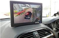 LCD screen mounted on the dashboard provides surround view including over-the-top visual of the vehicle.