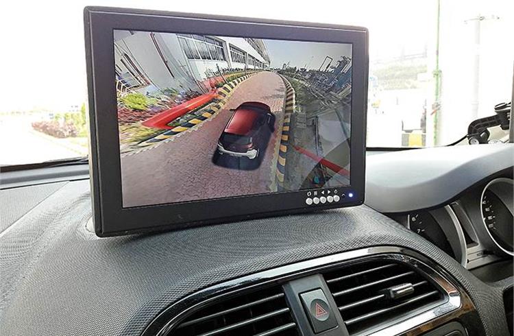 LCD screen mounted on the dashboard provides surround view including over-the-top visual of the vehicle.
