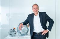 Mahle CEO Arnd Franz with two products for e-mobility: the e-compressor (left) and the MCT electric motor.