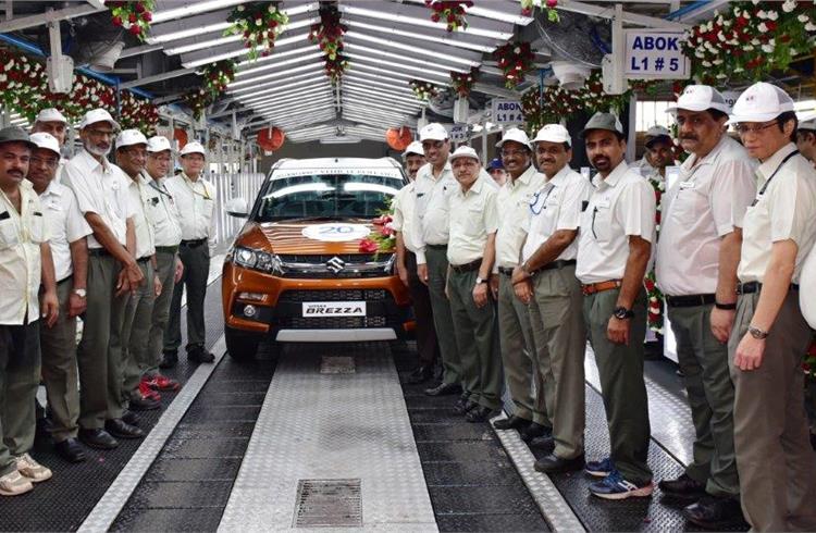 Kenichi Ayukawa, MD and CEO (to the right of the Maruti Vitara Brezza), is joined by Team Maruti Suzuki, as the 20-millionth car rolls out from the company’s Gurgaon plant.