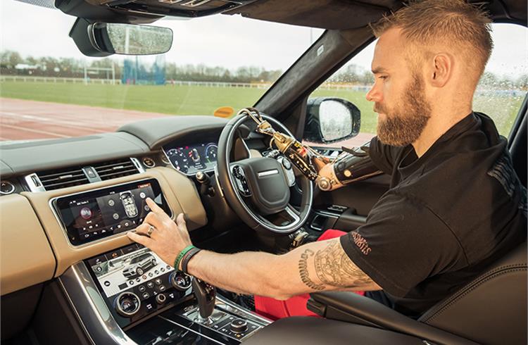 Mark Ormrod Invictus Games gold medallist testing the smart doors on a Range Rover Sport