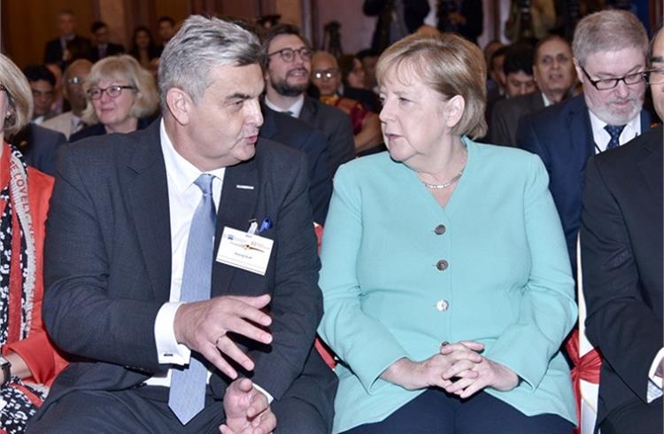Interview of the Fortnight: Georg Graf, President of the Indo-German Chamber iof Commerce, seen here with Chancellor Angela Merkel on her visit to India in early November (Image: Freudenberg India)