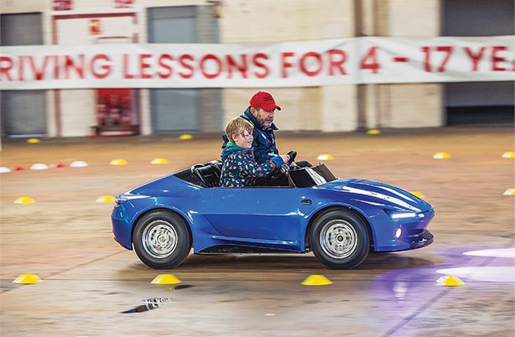 File image of a young kid getting driving lessons from an instructor in a safe and controlled environment.