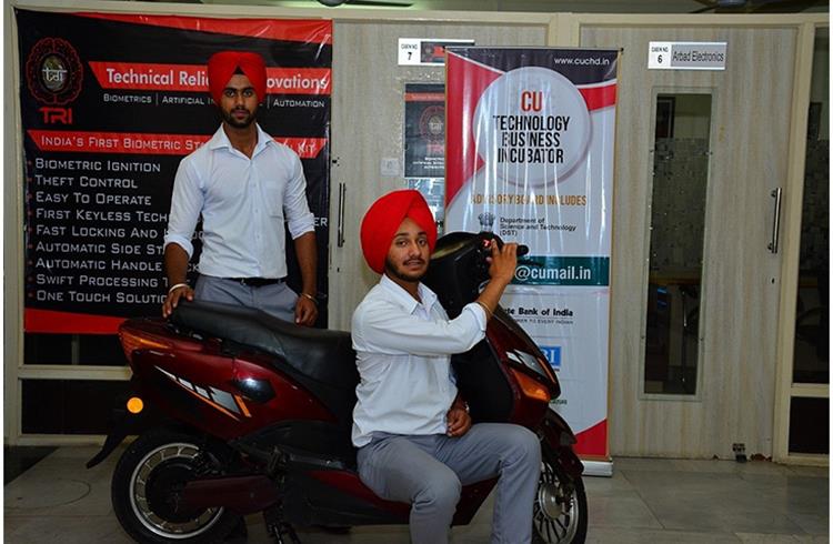 Automobile Engineering students of Chandigarh University, Khushwinder Pal Singh and Vikramjit Singh with their newly developed Biometeric security kit installed on a two-wheeler.