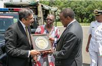 Arvind Mathew, Chief of International Operations, Mahindra & Mahindra, hands over a memento to President Uhuru Kenyatta of Kenya.