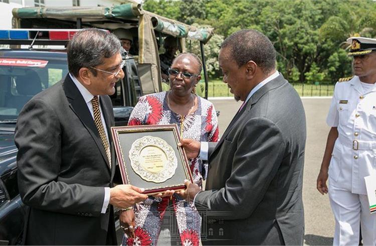 Arvind Mathew, Chief of International Operations, Mahindra & Mahindra, hands over a memento to President Uhuru Kenyatta of Kenya.