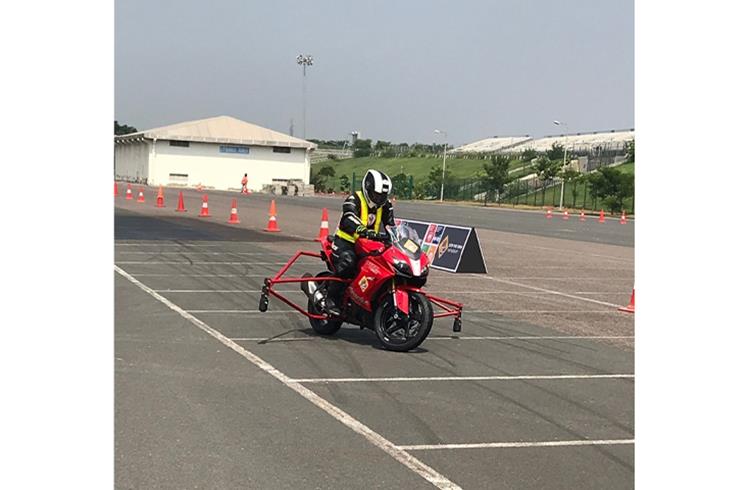 Rider astride a TVS Apache RR 310, equipped with a Continental-made dual-channel ABS system, tests the bike under hard emergency braking. 