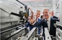 German Chancellor Olaf Scholz puts a test cell in the test chamber. In the background, Herbert Diess, Chairman of the Board of Management of Volkswagen AG, and Stephan Weil, Prime Minister of Lower Saxony.