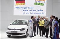 Prime minister Modi and chancellor Merkel speak to a young Indian apprentice who is training at VW India's Chakan plant.