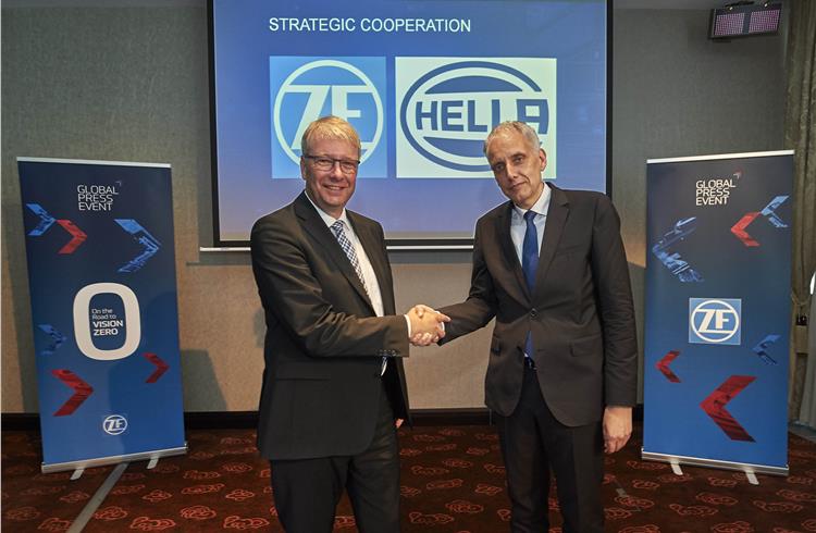 Dr. Stefan Sommer, CEO of ZF Friedrichshafen AG, and Dr. Rolf Breidenbach, CEO at Hella KGaA Hueck, seal the deal.