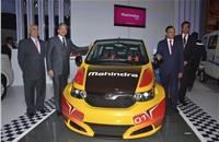 L-R: Mahindra & Mahindra’s Pravin Shah, chairman Anand Mahindra, Dr Pawan Goenka and Arvind Mathew, CEO, Mahindra Reva, with the all-electric e2o Sports car.