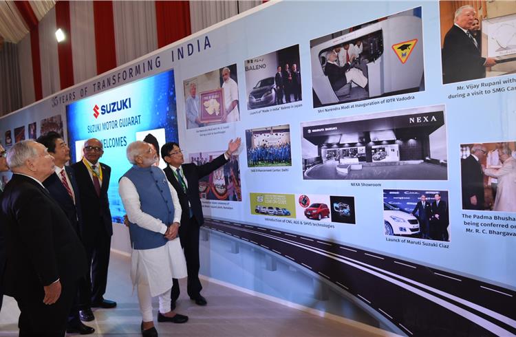 At the Suzuki booth at Mahatma Mandir Centre in Gandhinagar: Osamu Suzuki, chairman, Suzuki Motor; Japanese PM Shinzo Abe; RC Bhargava, chairman, Maruti Suzuki India; PM Narendra Modi and Kenichi Ayukawa, MD, Maruti Suzuki India.