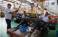 Front axle assembled with springs at a sub-assembly station. There are 25 stations on the assembly line with each station taking 10 minutes.