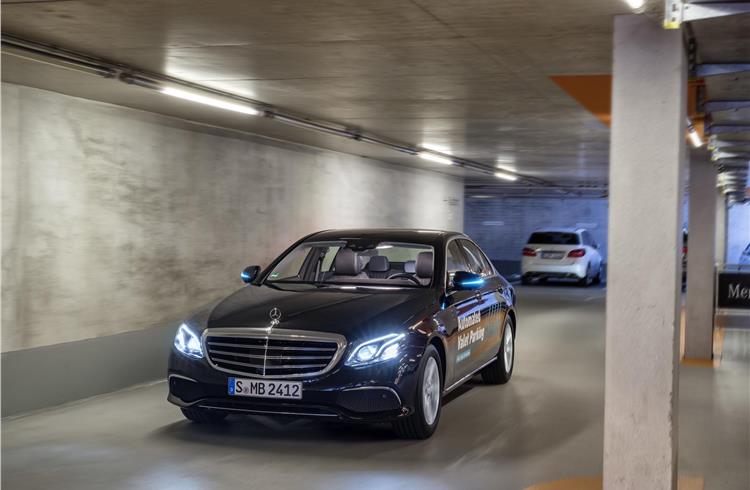 Cars proceed without a driver to an assigned parking space to a command issued by smartphone.