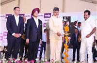 Andhra Pradesh Chief Minister lighting the lamp during the foundation stone laying ceremony of Apollo Tyres' facility in Andhra Pradesh.