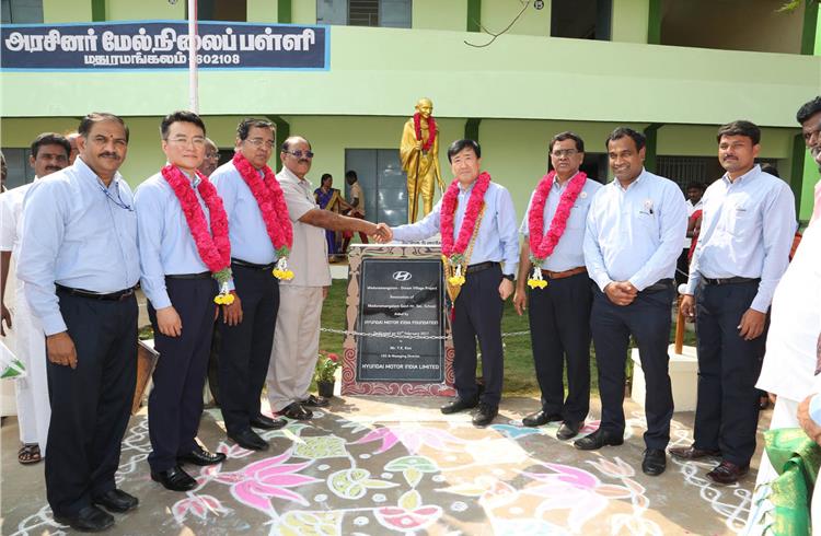 Y K Koo, MD, Hyundai Motor India, and other company staffers at the handover of the revamped Madhuramangalam village.