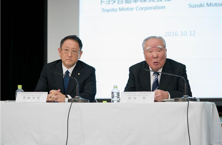File photograph of Toyota president Akio Toyoda and Suzuki Motor Corp chairman Osamu Suzuki.