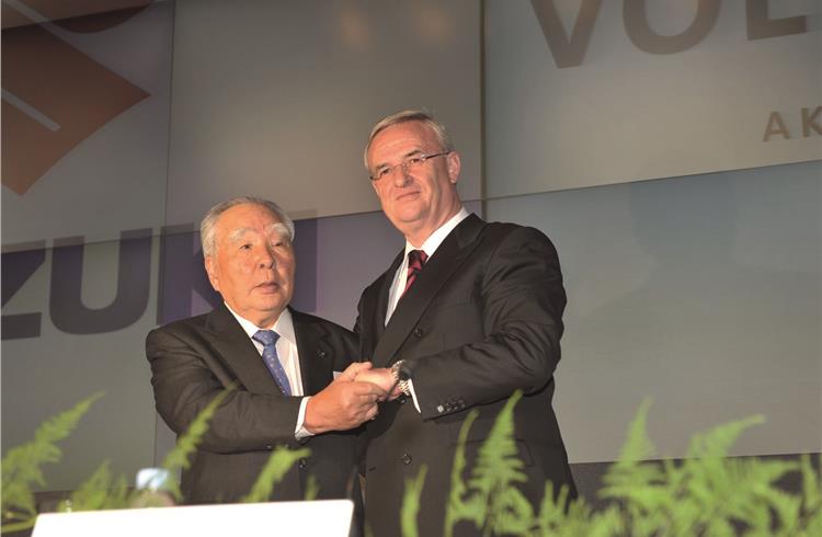 File photo of Osamu Suzuki, CEO, Suzuki, and Prof. Dr. Martin Winterkorn, chairman of the Board of Management of Volkswagen AG, on December 9, 2009.