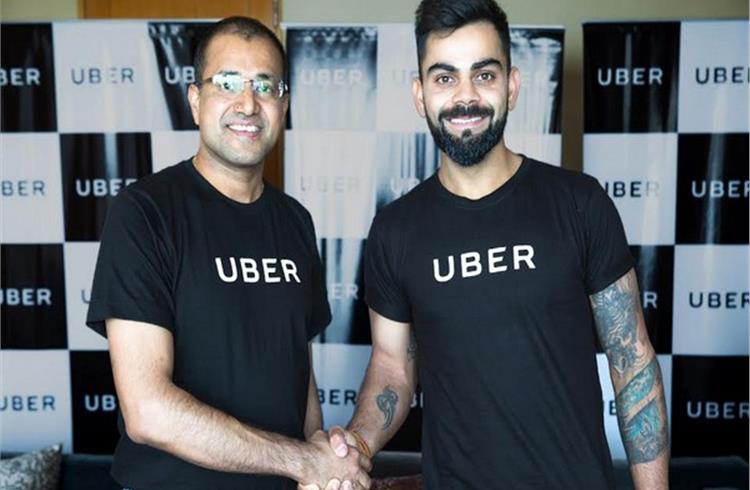 L-R Amit Jain, president Uber India and South Asia, and Virat Kohli.