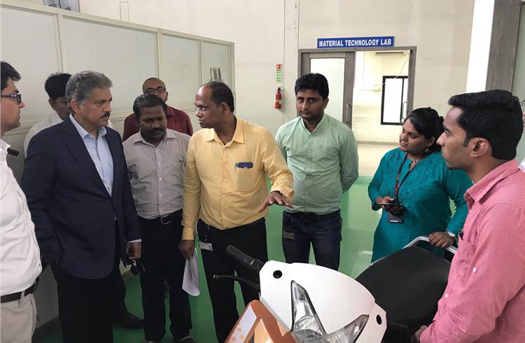 Anand Mahindra, chairman, Mahindra Group, seen at the two-wheeler R&D facility in Pune. The under-development electric scooter is seen in the foreground. (Anand Mahindra/Twitter)