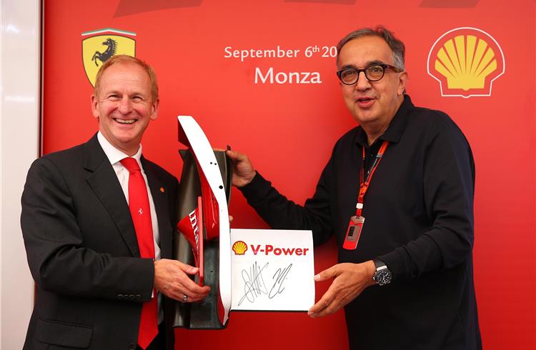 John Abbott, Shell Downstream director accepts a gift from Sergio Marchiomme, CEO of FCA