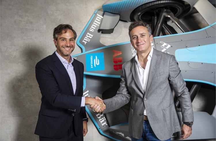 (L-R) Jamie Reigle, newly-appointed ceo of Formula E, shaking hands with Alejandro Agag, Chairman of Formula E, standing alongside the Gen2 car at the company’s headquarters in London.