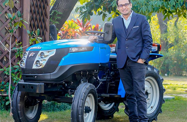 Raman Mittal, executive director, Sonalika Group with the Tiger Electric. The eco-friendly tractor has a top speed of 24.93kph and a battery backup of 8 hours while operating with 2-tonne trolley.