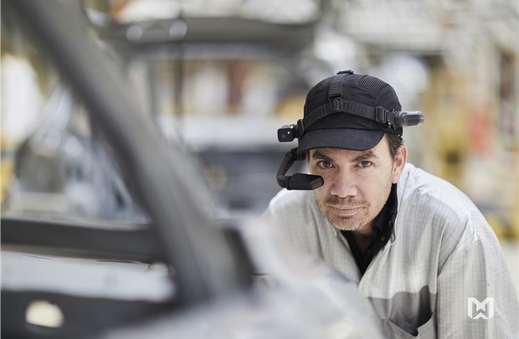 Factory employees at Groupe PSA wearing RealWear’s assisted reality headsets (HMT-1s), which helps improve uptime, empower and connect workers with other experts. 