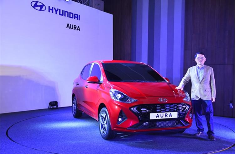 SS Kim, MD and CEO, Hyundai Motor India with the Aura compact sedan, which is to be officially launched next year.