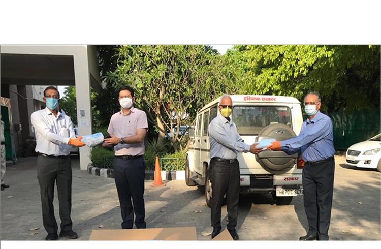 From Left: Rajiv Gandhi, Member Executive Board, Maruti Suzuki seen handing over the first batch of 200,000 units of triple-ply face masks to Amit Khatri, IAS, District Magistrate, Gurugram; Ram Natarajan, ED & CEO, Maruti Krishna Group handing them over to VS Kundu ACS Haryana and CEO,GMDA.