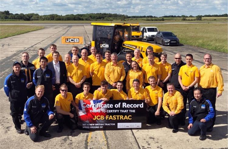 The happy JCB team with the proof of the run officially ratified by Guinness World Records.