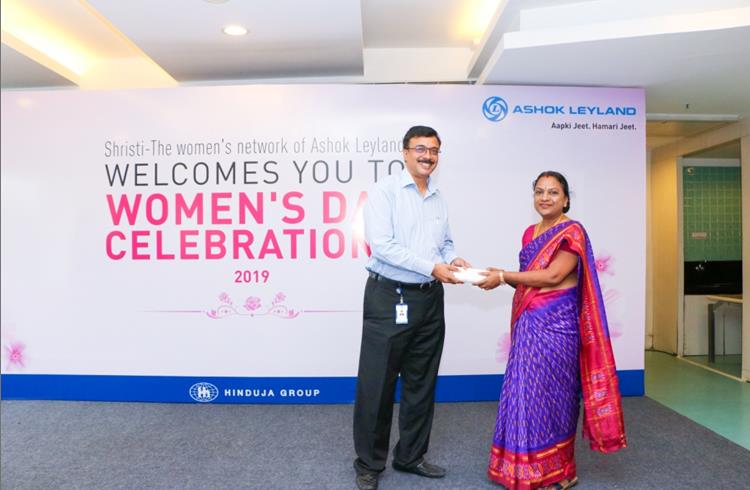 Ashok Leyland's MD Vinod K Dasari felicitating a women employee on the eve of International Women's Day. 