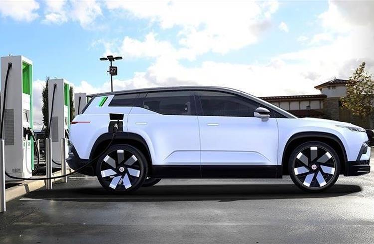 The Fisker Ocean at an Electrify America charging station. The high-mounted side indicators double as charge indicators – signaling a full battery when the green light bar is lit to the top.