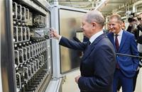 German Chancellor Olaf Scholz puts a test cell in the test chamber.