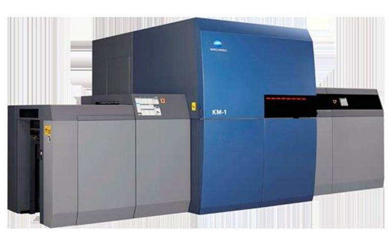The Konica Minolta AccurioJet KM-1 is a sheetfed duplex B2-format digital inkjet press. Konica Minolta makes the print engine, inks and DFE, while Komori supplies the transport system. Its 600dpi printheads with piezo shear technology are fitted in pairs to give 1,200dpi. There are eight pairs per full-width print bar and one print bar per colour. Initially, the presses will be wide-gamut CMYK, with five and six colour options in future. It takes oversized B2 sheets up to 585x750mm, allowing six-up A4s. The production presses are claimed to print 3,000 simplex or 1,500 duplex B2 sheets per hour at up to 1,200dpi, with full variable print