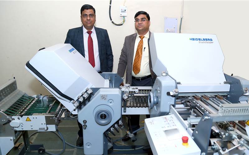 (l-r) Pradeep Kumar Jain and Anuj Kumar Jain with the Stahl paper folding machine