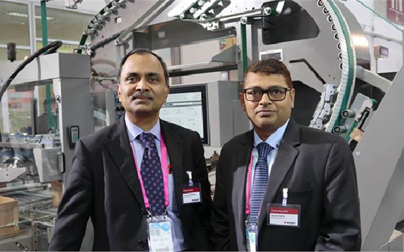 Venugopal Menon (l), business director for sheetfed and Sachin Patil, regional sales manager for Bobst India, next to Bobst’s at the stand which displayed the CartonPack 4 running in line with Bobst Meilong III, which in India is called the ExpertFold. There’s one CartonPack machine in India, installed at the ITC. Any high-speed packaging finishing line is of no use if the end product cannot be efficiently packed. Unfortunately, in India, converted cartons are packed in small packs, manually, which defeats the purpose of automation of all previous finishing processes. The CartonPack 4 can pack more than two lakh carton boxes per hour and can run for 30 minutes without an operator