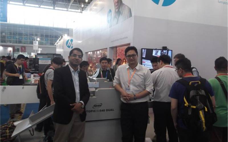 Anuj Mehta of Paper Bind along with a GMP representative, showcasing GMP's spot lamination machines at HP's stall