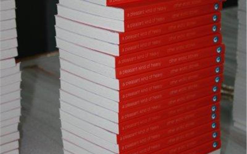 A stack of soft bound books; ready to be packed in boxes